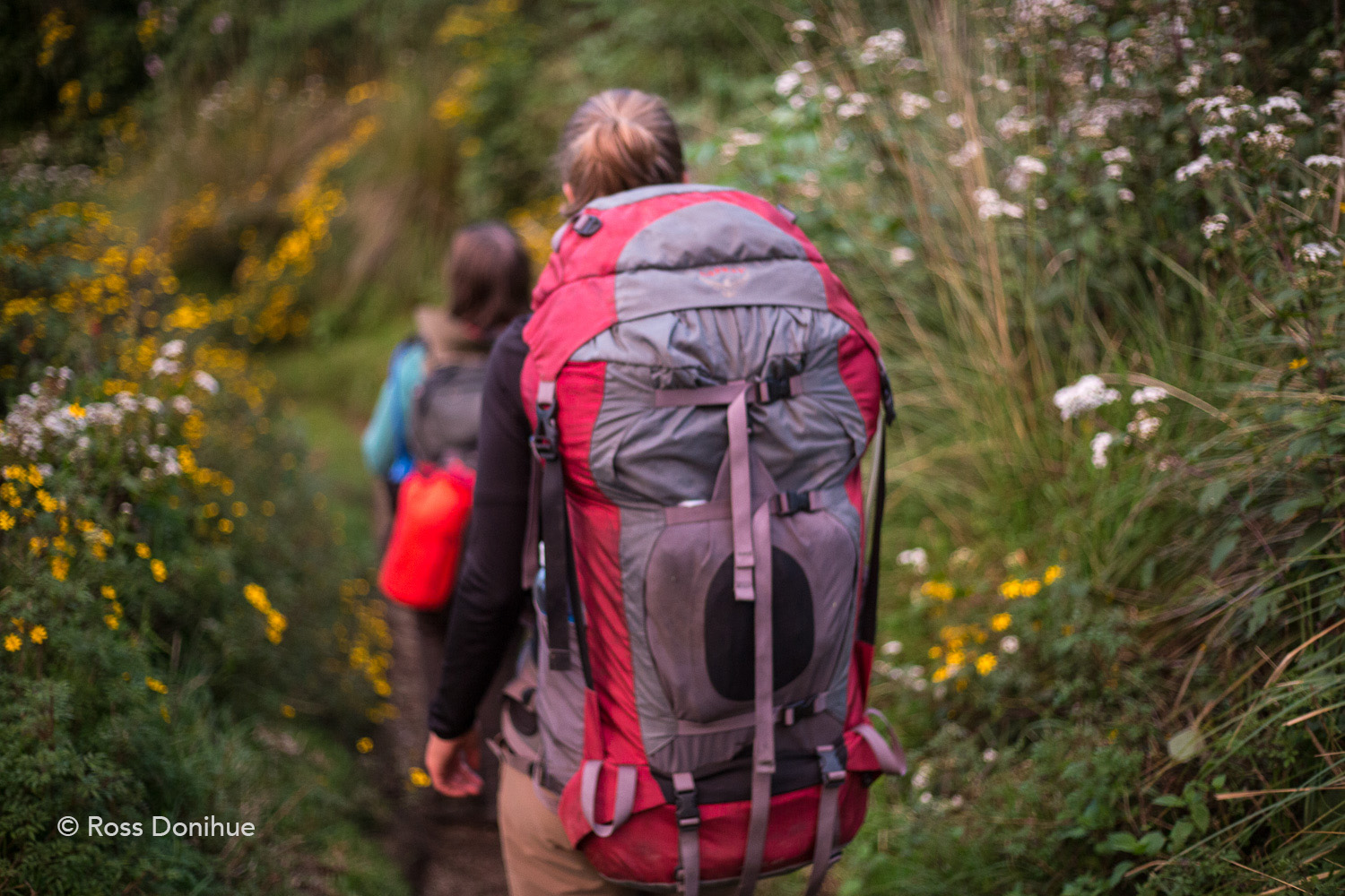 Stephanie and Gabby hiking down Volcán Santa Maria with packs full of camera equipment.